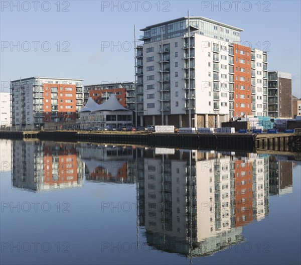 Modern apartments architecture reflected in water Ipswich Wet Dock waterside redevelopment, Ipswich, Suffolk, England, Uk