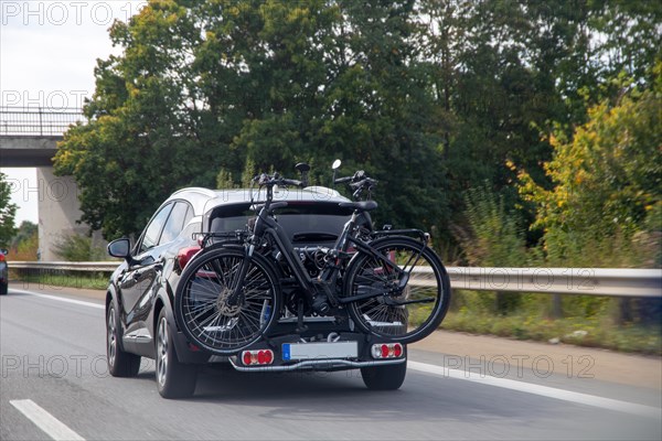 Car on the motorway transporting bicycles on the rear rack
