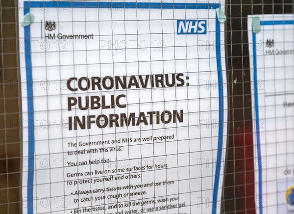 National Health Service NHS government information Coronavirus notice glass door entrance to GP surgery, Alderton, Suffolk, England, UK, -15 March 2020