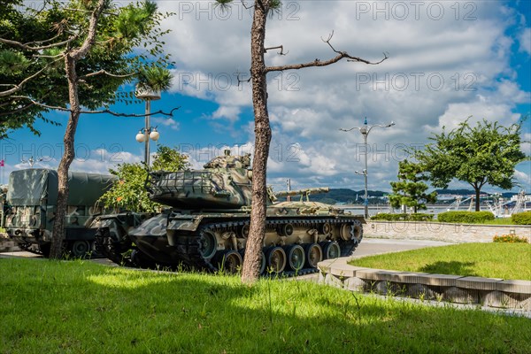 Rear side view of M48 tank on display at seaside park under blue cloudy sky in Seosan, South Korea, Asia