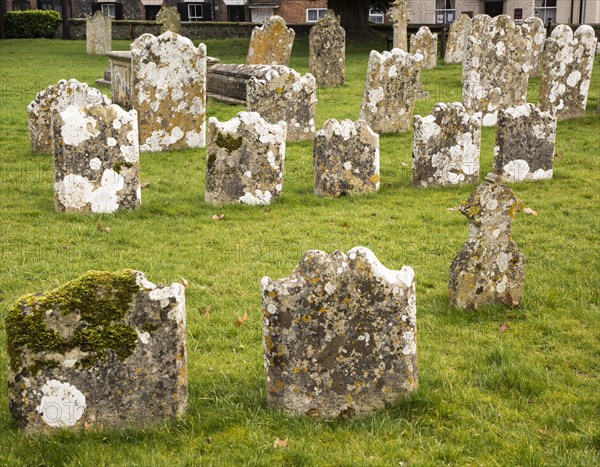 Weathered limestone gravestones, Amesbury Abbey church, Amesbury, Wiltshire, England, UK