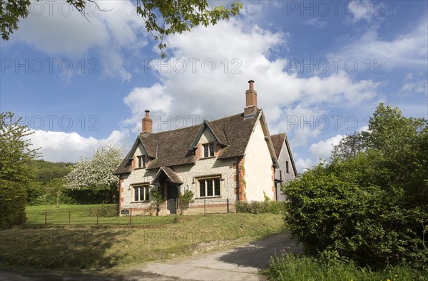 Attractive detached house built from chalk stone in village of Compton Bassett, Wiltshire, England, UK