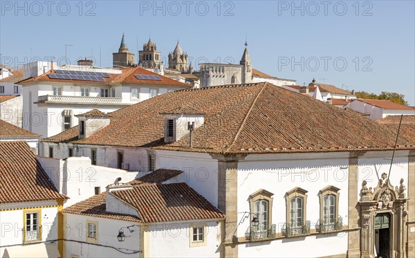 Panoramic style cityscape views over pan tile rooftops and whitewashed buildings in the city centre of Evora, Alto Alentejo, Portugal, southern Europe, Europe