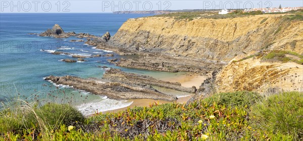 Rocky coastal landscape Praia dos Alteirinhos beach in bay with rocky headland part of Parque Natural do Sudoeste Alentejano e Costa Vicentina, Costa Vicentina and south west Alentejo natural park, Zambujeira do Mar, Alentejo Littoral, Portugal, southern Europe, Europe