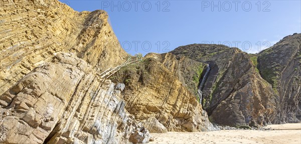 Folded sedimentary rock strata dipping downwards in cliff at Praia dos Alteirinhos, Zambujeira do Mar, Parque Natural do Sudoeste Alentejano e Costa Vicentina, Costa Vicentina and south west Alentejo natural park, Zambujeira do Mar, Alentejo Littoral, Portugal, southern Europe, Europe