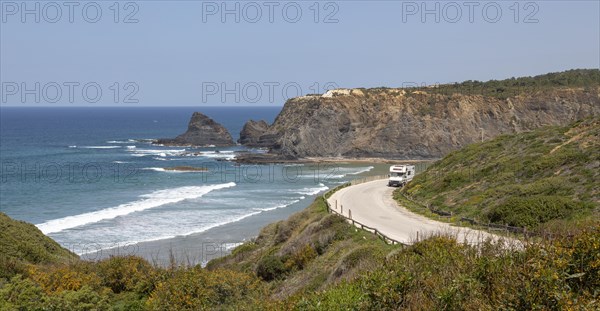 Motorhome parked at viewpoint of Atlantic Ocean waves breaking on rocky headland and bay with sandy beach, Praia de Odeceixe, Algarve, Portugal, Southern Europe, Europe