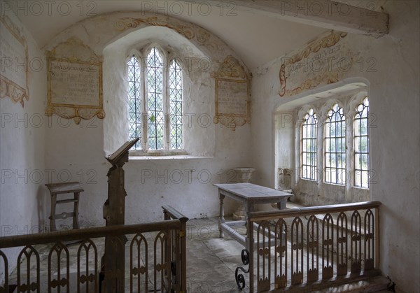 Chancel All Saints church, Leigh, Wiltshire, England, UK interior with ancient wall texts old wooden furniture