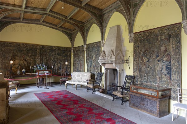 Furniture and wall tapestries in the Morning Room inside Berkeley castle, Gloucestershire, England, UK