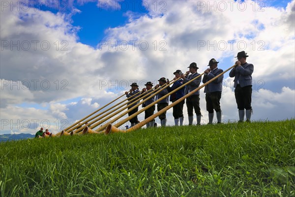 Alphorn players in Bavaria Germany . The alphorn is a traditional wind instrument in the Alps (Waltenhofen, 03/10/2019)