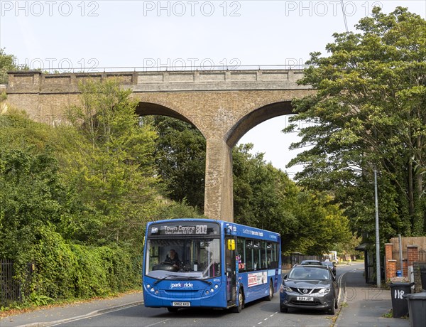Park and Ride bus beneath railway viaduct built 1876, Spring Road, Ipswich, Suffolk, England, UK