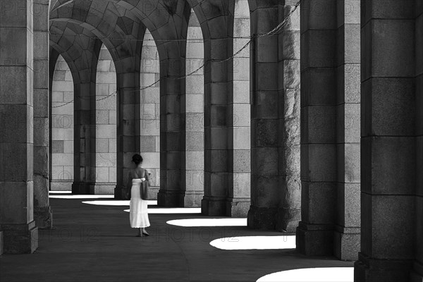 Lady in a white dress in the arcade of the Congress Hall, unfinished National Socialist monumental building on the Nazi Party Rally Grounds, Nuremberg, Middle Franconia, Bavaria, Germany, Europe
