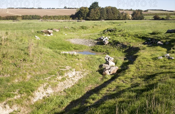 Dried up river bed and course in summer River Kennet, West Overton, Wiltshire, England, UK