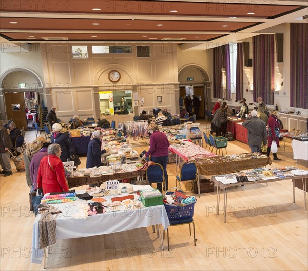 Shoppers browsing stalls at a Flea market inside the Corn Exchange building, Devizes, Wiltshire, England, UK