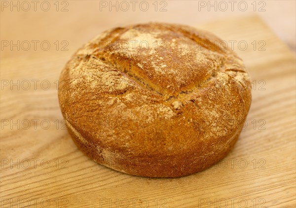 Close up of freshly baked loaf of bread on kitchen table