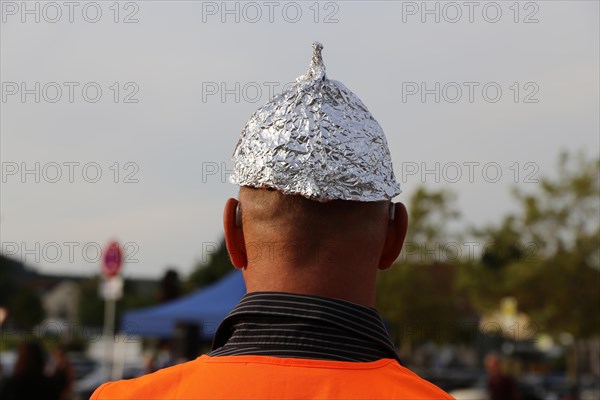 Self-deprecating aluminium hat wearer at a Monday demonstration against the corona measures in Bad Duerkheim under the motto Talking together, finding common ground