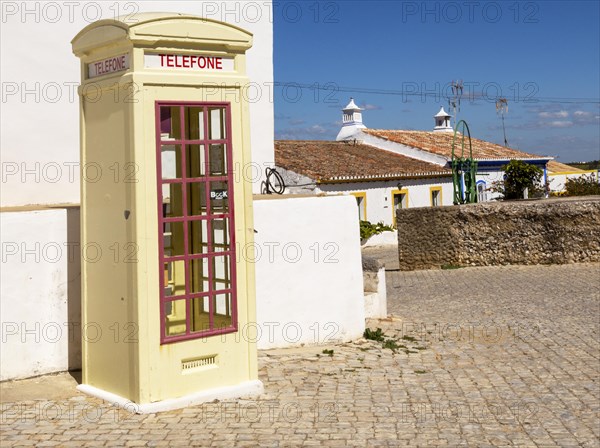 Old fashioned Telephone Telefone box kiosk in street of traditional Portuguese village, Cacela Velha, Algarve, Portugal, Southern Europe, Europe