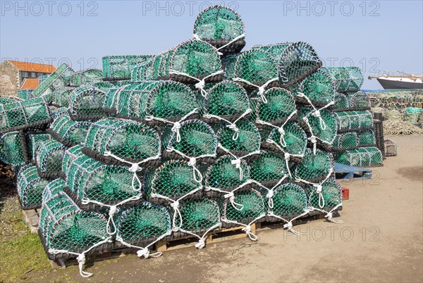 Piles of new lobster pots on Holy Island, Lindisfarne, Northumberland, England, UK