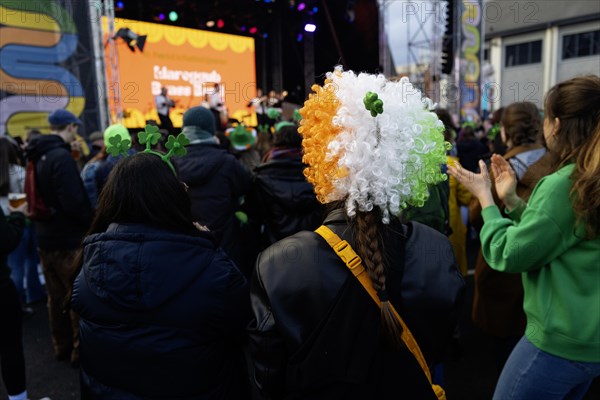 Lots of pride in being Irish on show with green hats and wigs of green, white and gold, the national colours of Ireland on St Patrick's day. Dublin, Ireland, Europe