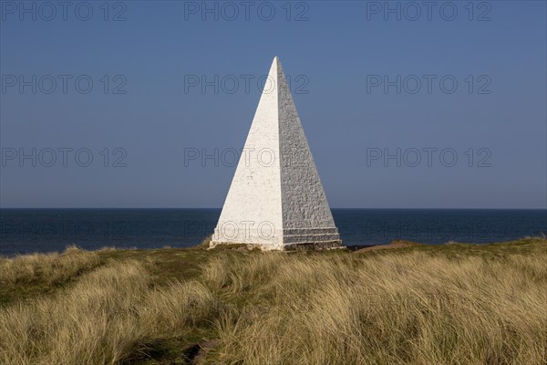 Emmanuel Head white pyramidal navigation beacon, Holy Island, Northumberland, England, UK built 1801-10 by Trinity House