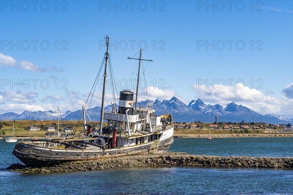 Wreck of a cutter against the backdrop of the mountains in the harbour of Ushuaia, Tierra del Fuego Island, Patagonia, Argentina, South America