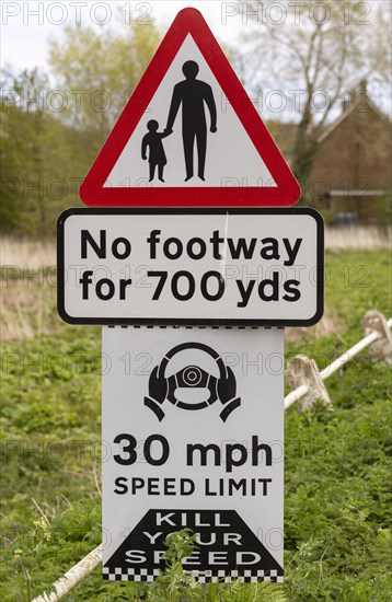 Road traffic signs warning of hazards no footway 30 mph speed limit, Shottisham, Suffolk, England, UK