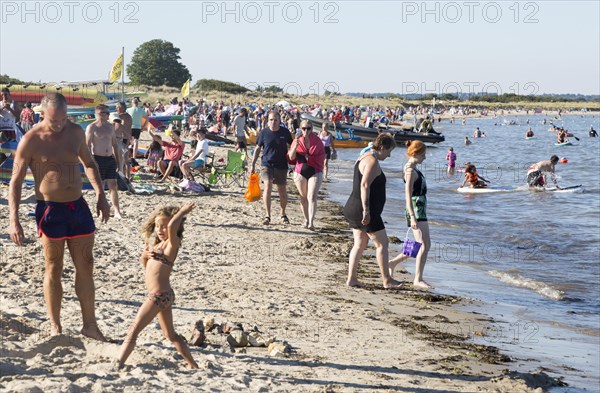 Late afternoon crowded summer sandy beach, Studland Bay, Swanage, Dorset, England, UK