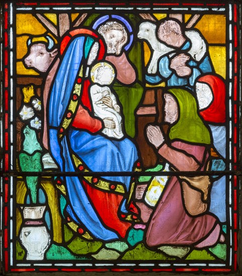 Nativity scene with blessed Virgin Mary and baby Jesus and shepherds, nineteenth century stained glass window at Holy Trinity church, Easton Royal, Wiltshire, England, UK unknown artist
