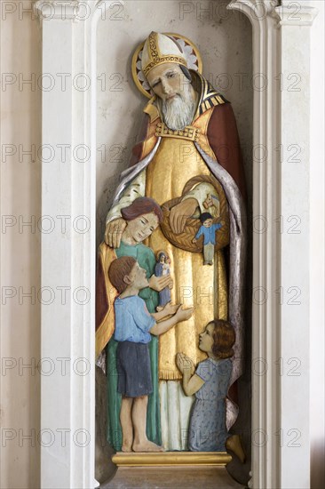 Sculpture statue of Saint Nicholas with children inside village parish church of Saint Nicholas, Hintlesham, Suffolk, England, UK