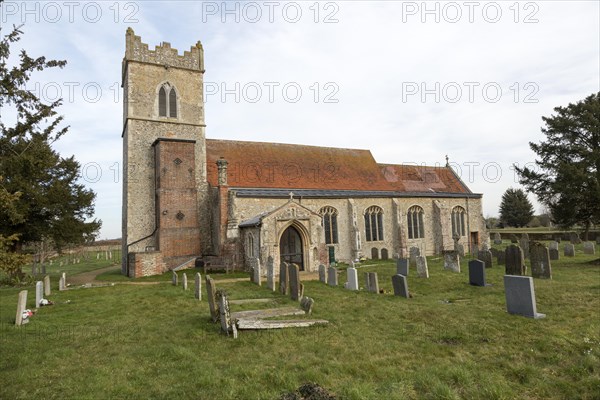 Graves in the churchyard of the village parish church of Saint Mary, Ellingham, Norfolk, England, UK