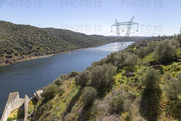 Barragem do Alqueva dam part of the multipurpose water management project on the Rio Guadiana river hydro-electricity generation electricity power lines