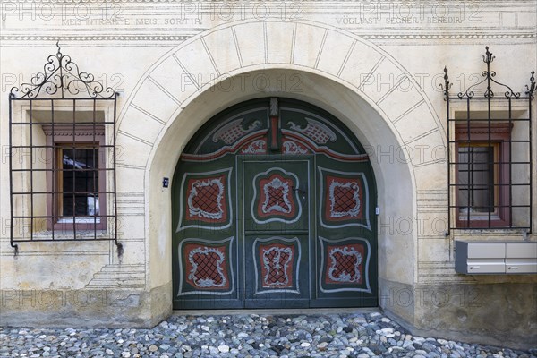 Large painted wooden door, window, historic house, sgraffito, facade decorations, Ardez, Engadin, Grisons, Switzerland, Europe