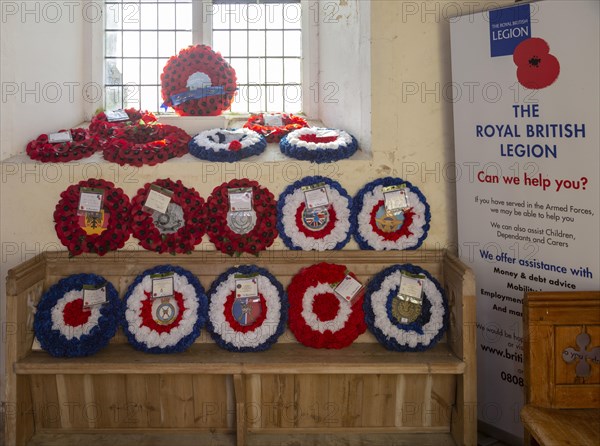 Village parish church Shotley, Suffolk, England, UK Royal British Legion remembrance poppy wreaths