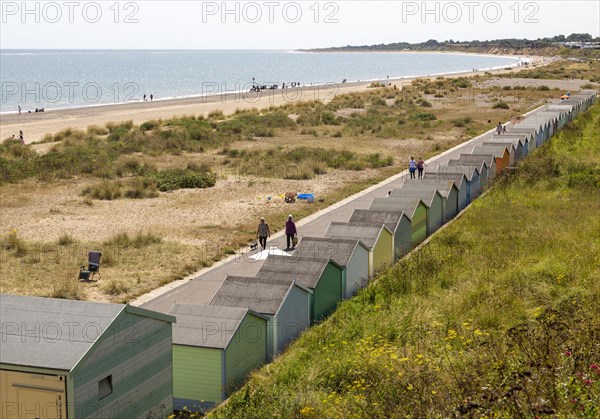 Coastline in summer sandy beach and beach huts, Pakefield, Lowestoft, Suffolk, England, UK