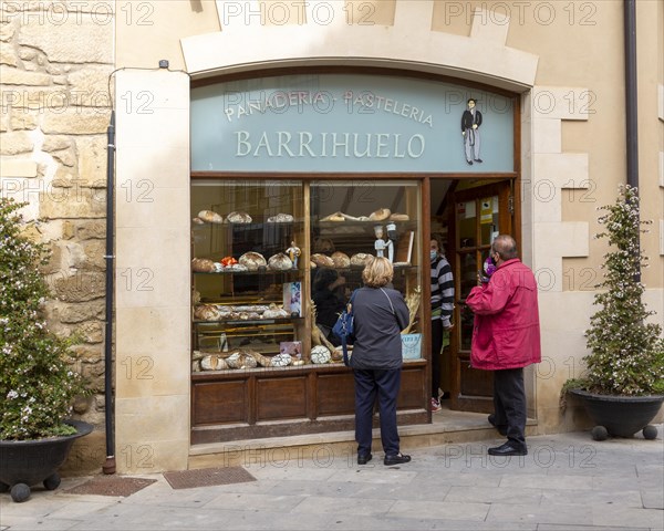 Customers outside small bakery shop in village of Elceigo, Alava, Basque Country, northern Spain