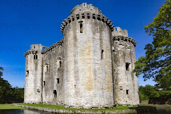 Historic stone ruins and moat of Nunney Castle, Somerset, England, UK