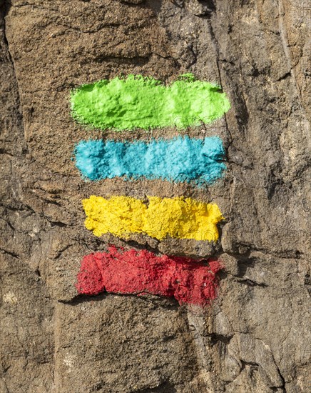 Footpath marker way mark sign painted in green, blue, yellow and red stripes for the Ruta Vicentina long distance footpath, the Fisherman's Trail and Historical Way, within the Southwest Alentejo and Vicentina Coast Natural Park, south west Portugal, southern Europe