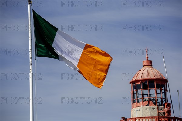 Irish tricolour national flag blowing in the brezze at Dun Laoghaire. Dublin, Ireland, Europe
