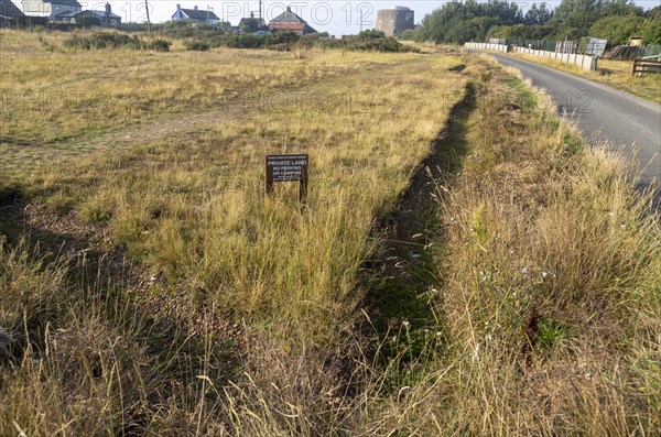 Ditches dug by residents to prevent visitors from parking at summer tourist hotspot, Shingle Street, Suffolk, England, UK