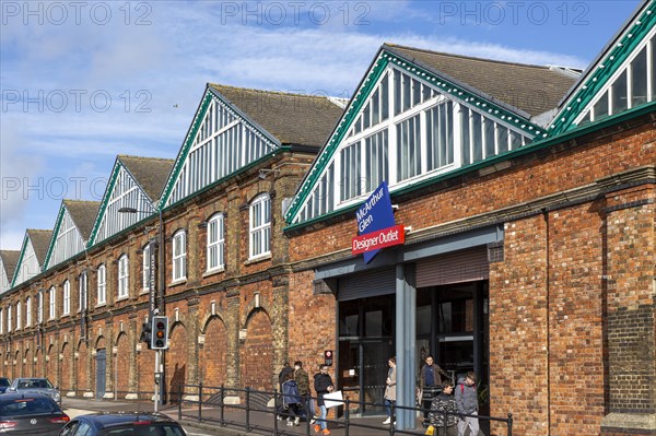 McArthur Glen designer outlet west entrance into former railway works, Swindon, Wiltshire, England, UK