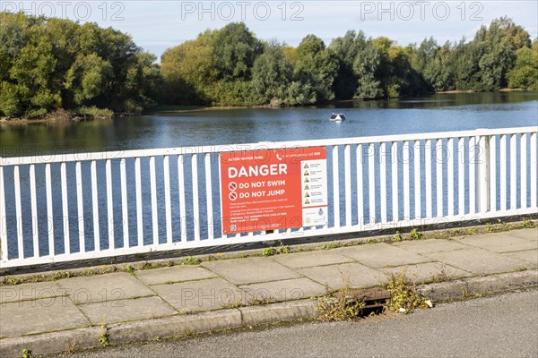 Alton Water reservoir lake, Tattingstone, Suffolk, England, UK notice warning of dangers do not swim or jump