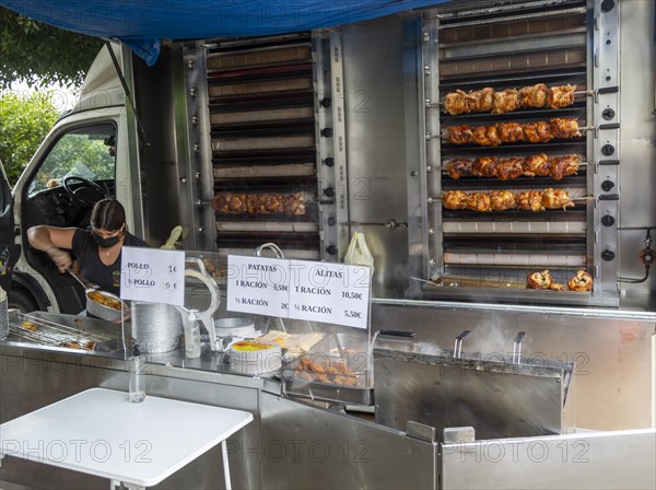 Mobile shop vehicle selling spit roasted chicken products from van, Mojacar, Almeria, Spain, Europe