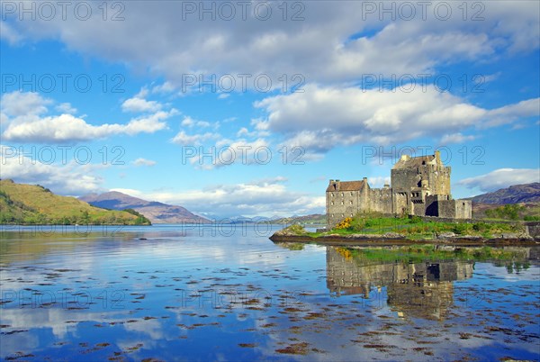 Eilean Donan Castle reflected in the water on a calm evening, filming location for James Bond, Highlander, Rob Roy, Scotland, Great Britain