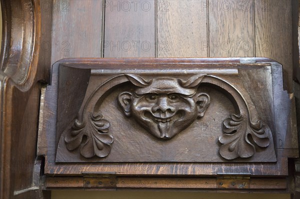 Church of Saint Mary of the Assumption, Ufford, Suffolk, England, UK grotesque devil face on misericord bench seat