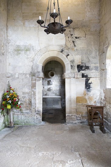 Interior stone arch leading to altar inside Saxon church of Saint Laurence, Bradford on Avon, Wiltshire, England, UK probably built circa 1000 AD