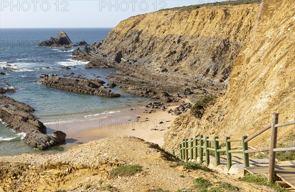 Rocky coastal landscape Praia dos Alteirinhos beach in bay with rocky headland part of Parque Natural do Sudoeste Alentejano e Costa Vicentina, Costa Vicentina and south west Alentejo natural park, Zambujeira do Mar, Alentejo Littoral, Portugal, southern Europe, Europe