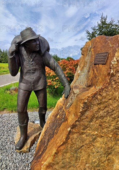 Bronze statue at the old customs office with the title The smuggler, coffee smuggling, border region to Belgium, High Fens, Muetzenich, Monschau, North Rhine-Westphalia, Germany, Europe