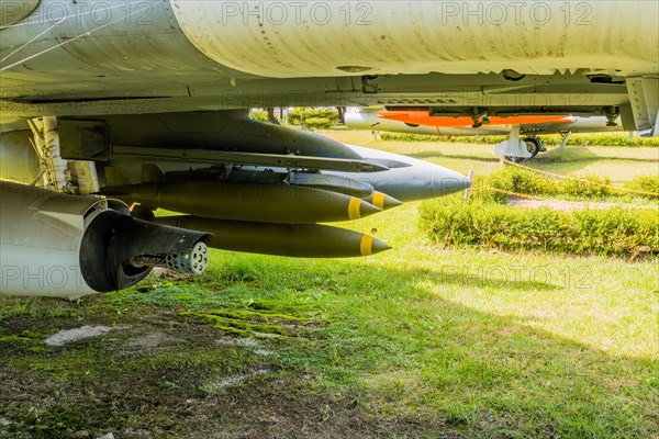 Battery of missiles and front of machine gun mounted under military jet aircraft on display in public park in Seosan, South Korea, Asia