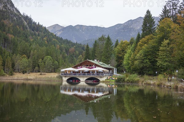 Pflegersee with inn under a cloudy sky, Garmisch-Partenkirchen, Werdenfelser Land, Upper Bavaria, Bavaria, Germany, Europe