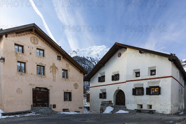 Historic houses, sgraffito, facade decorations, window shutters, mountain peaks with snow, winter, Guarda, Engadin, Grisons, Switzerland, Europe