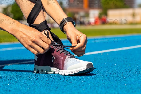 Young sportswoman wears running shoes from the Swiss shoe brand ON